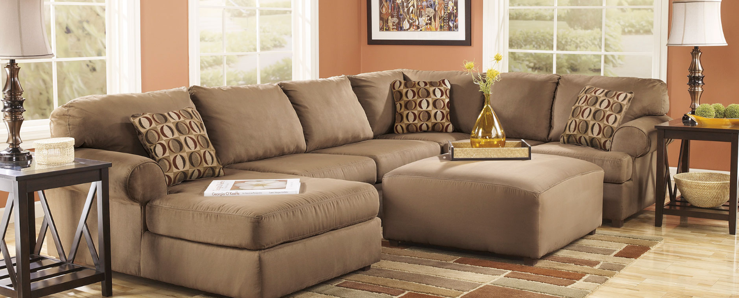 Image of Ashley Furniture Signature Design Hogan Sectional Sofa - A comfortable and stylish seating option for your living room