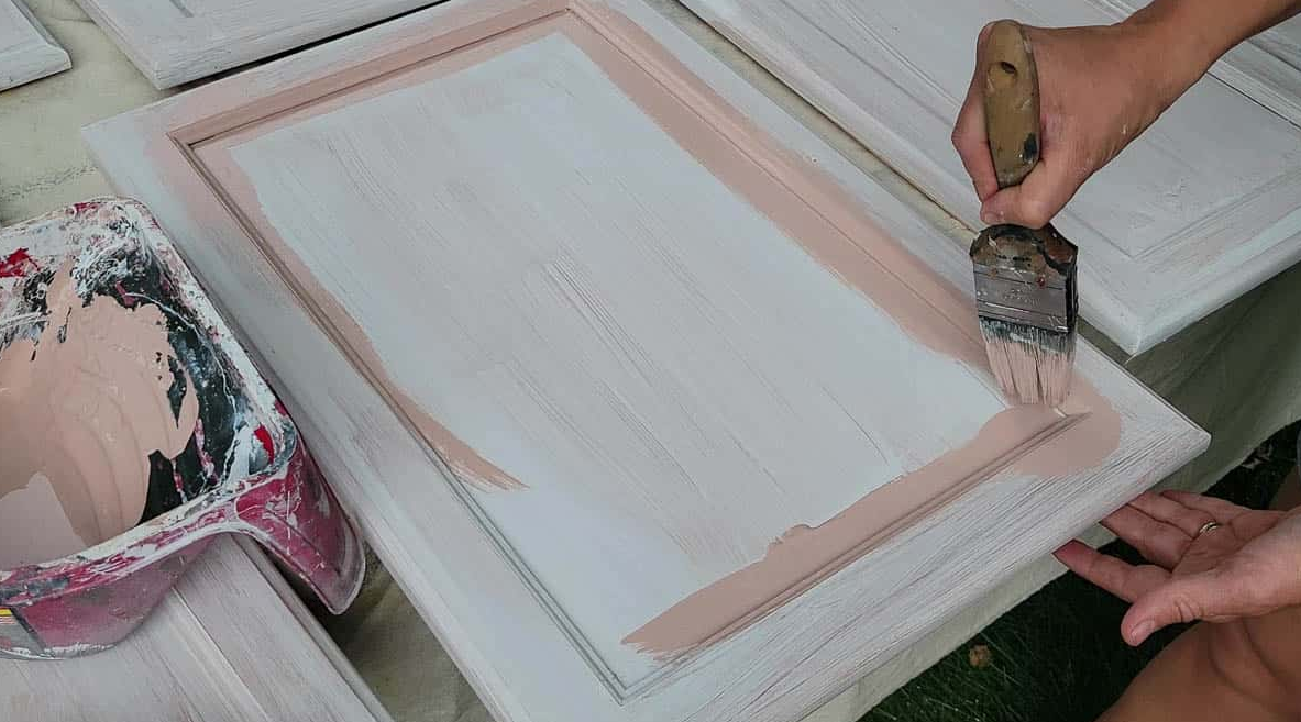 Applying primer to ensure paint adhesion and prevent chipping or peeling
