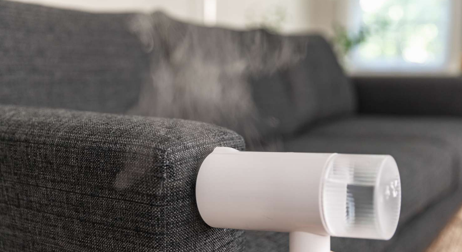 Steam cleaning the sofa for a thorough and sanitizing clean